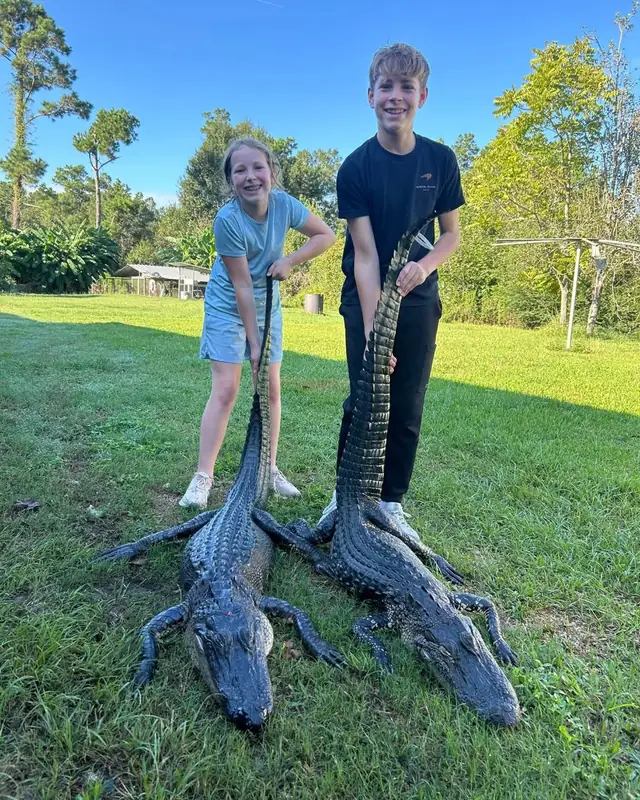 Two young hunters with alligators taken on a guided family hunt