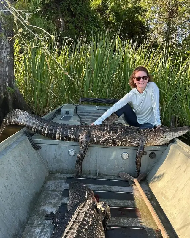Jon boat in a Louisiana cypress swamp during a women's alligator hunt